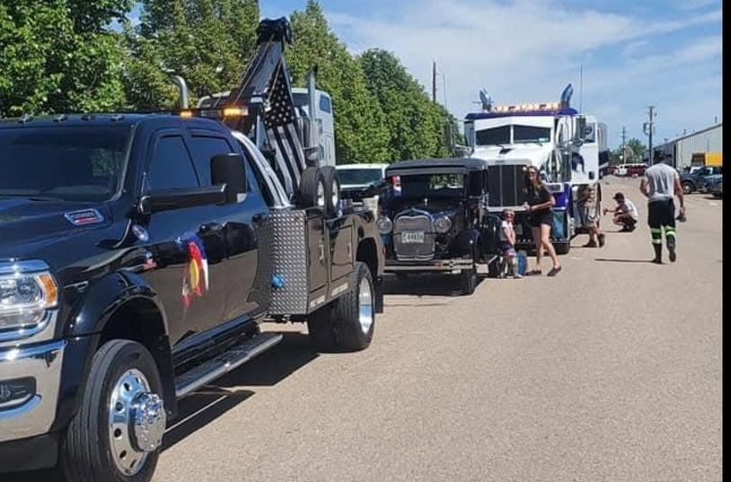 Multiple Spartan heavy wreckers and service trucks lined up with crew